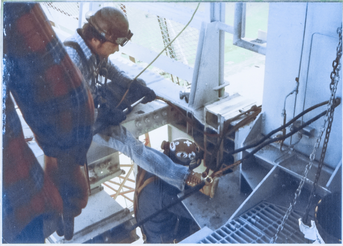 Union ironworkers from Local 808 connect the Intertank Access Arm to the Fixed Service Structure at Space Shuttle Launch Complex 39-B, Kennedy Space Center, Florida.